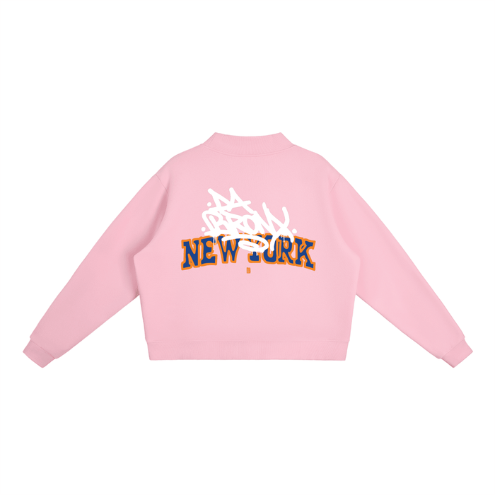Pink cropped hoodie with Bronx New York graffiti graphic, bold streetwear style