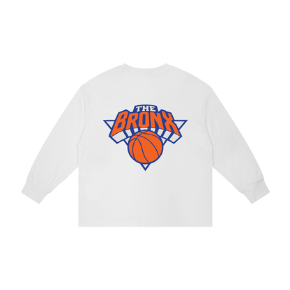 White long sleeve tee with 'The Bronx' basketball graphic, bold streetwear design inspired by NYC culture